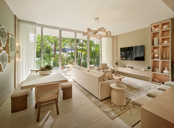 a living room with a large television and a table