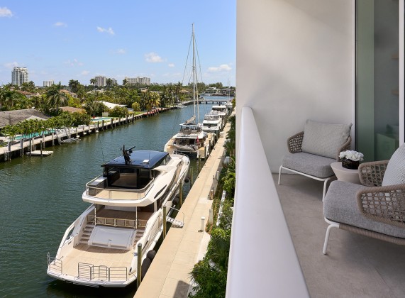 a balcony with a view of boats and a dock