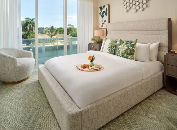 a bed with a tray of food on it