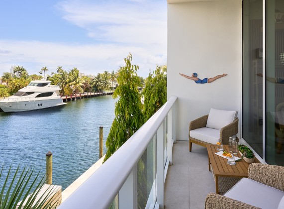 a person on a balcony with a body of water