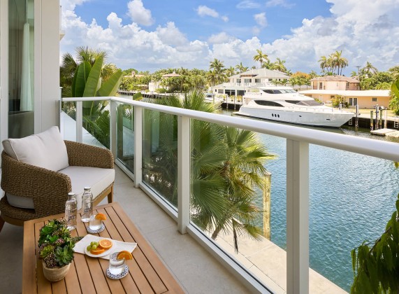 a balcony with a view of a body of water and a boat