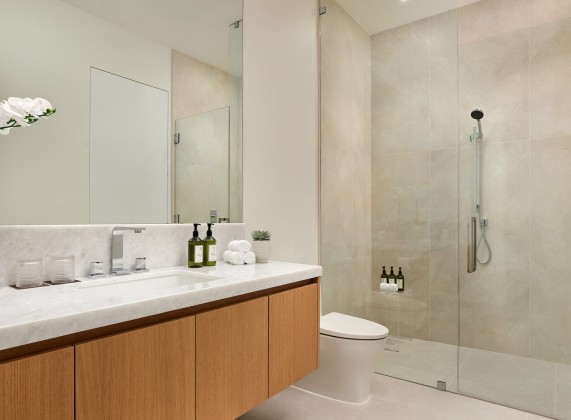 a bathroom with a glass shower and sink