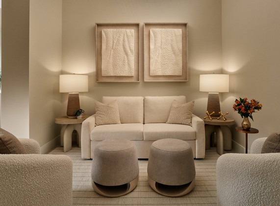 a room with a couch and two chairs