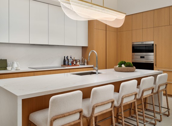 a kitchen with white cabinets and white countertops