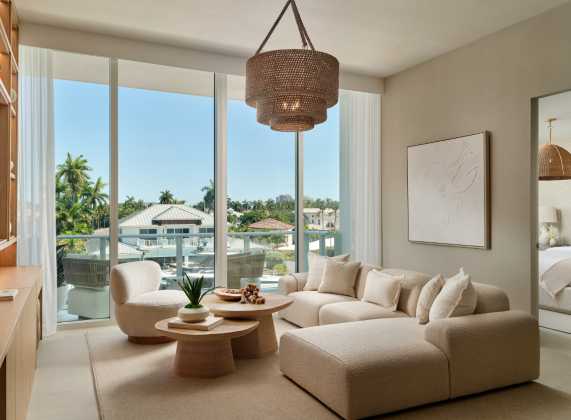 a living room with a large chandelier and couches