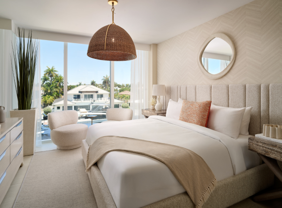 a bedroom with a large bed and a large mirror
