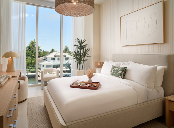 a bed with a tray of food on it