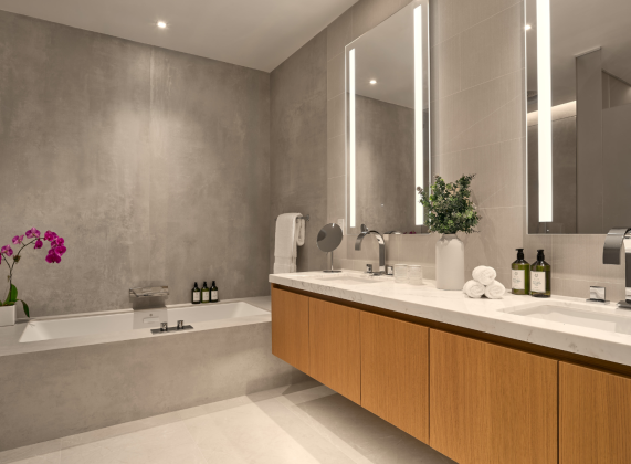 a bathroom with a large mirror and a tub