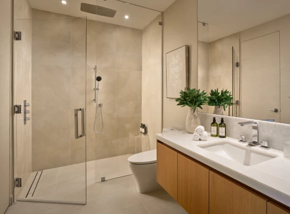 a bathroom with a glass shower and sink