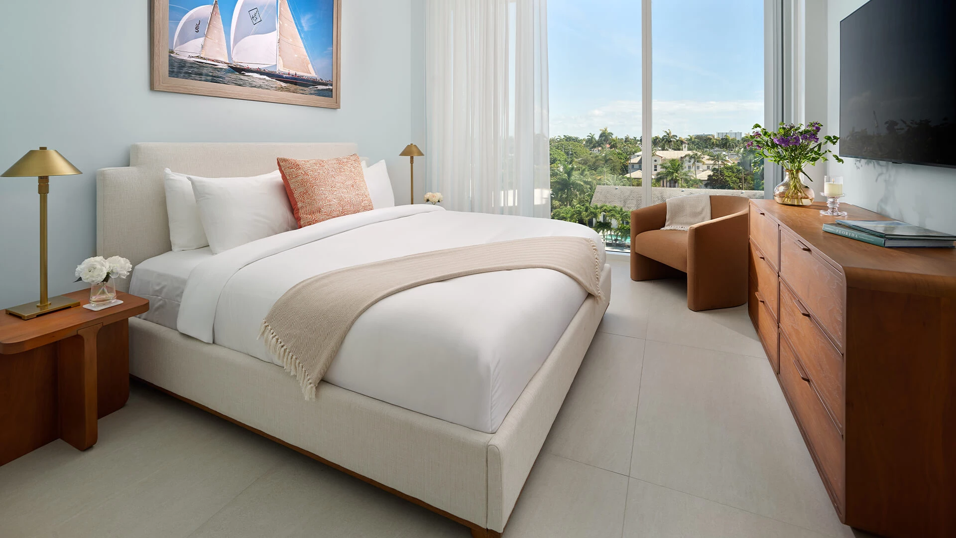 a bed in a room with a chair and a window