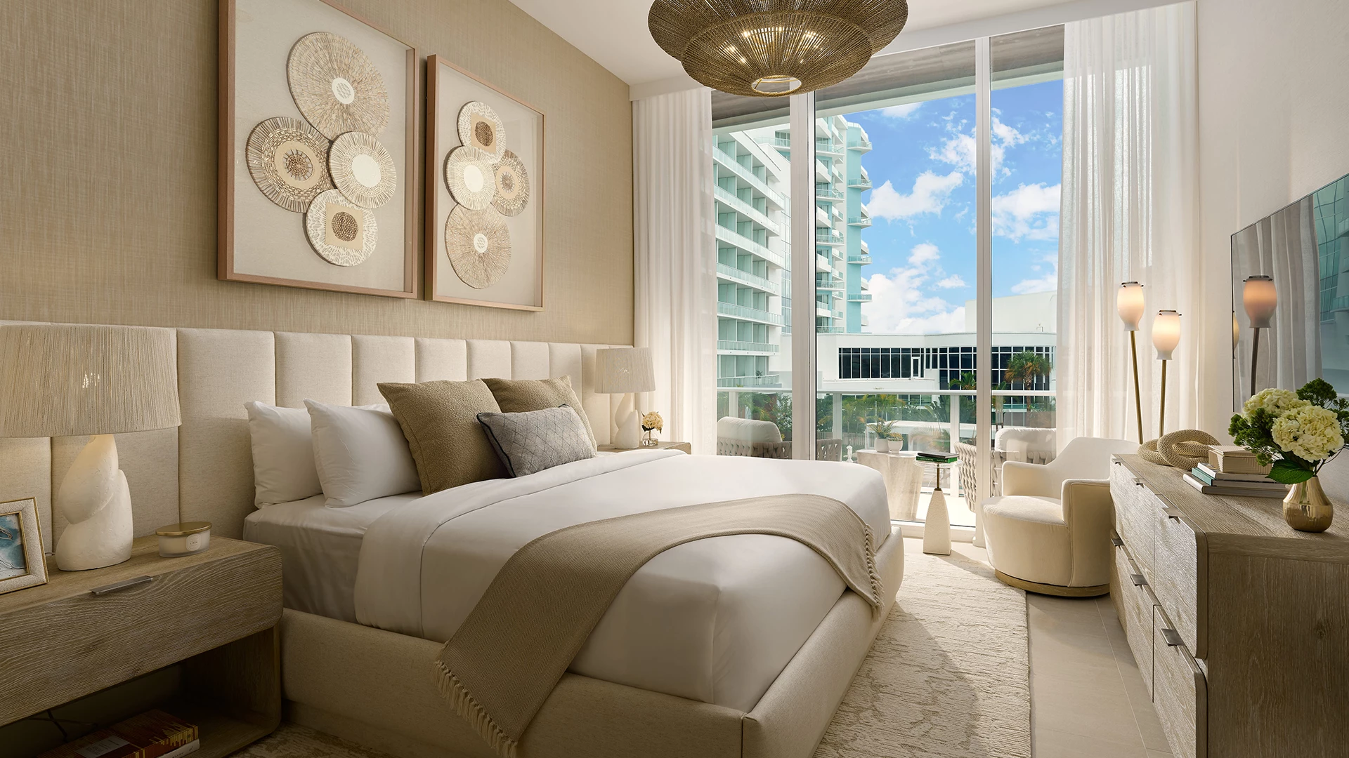 a bedroom with a large bed and a chandelier