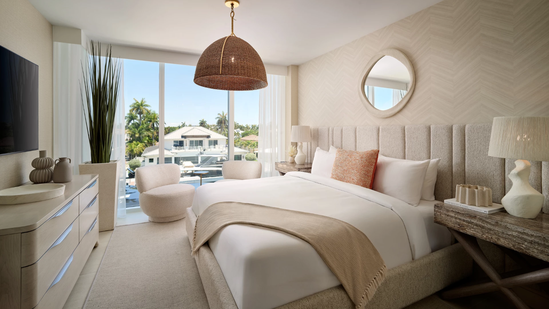 a bedroom with a large bed and a large mirror