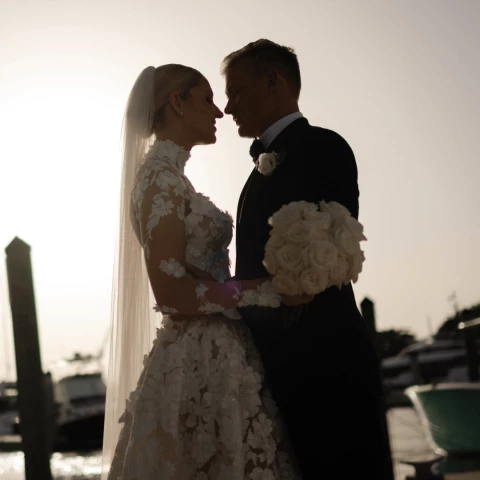 a man and woman in wedding attire kissing