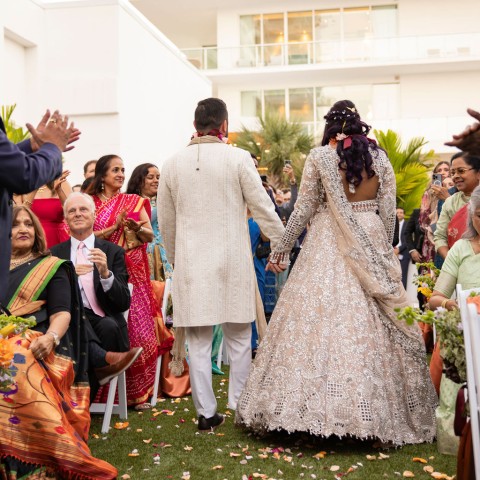 a man and woman walking down the aisle