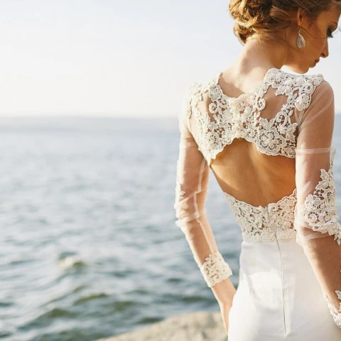 back of bride next to the water