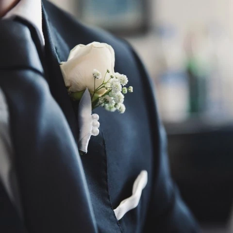 close up image of man with white rose