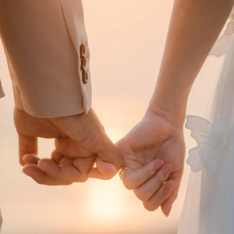 a close up of hands holding each other