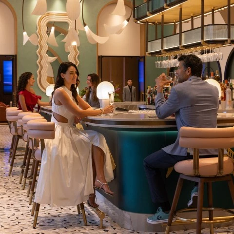 a man and woman sitting at a bar