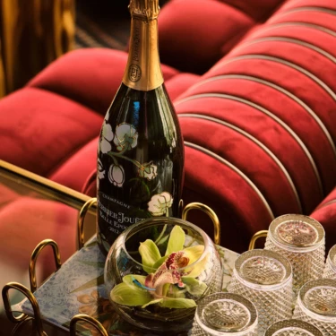a bottle of champagne and glasses on a tray