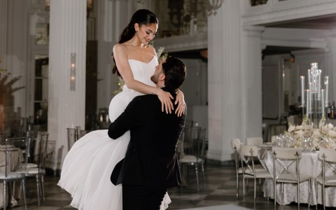 a man holding a woman in a white dress