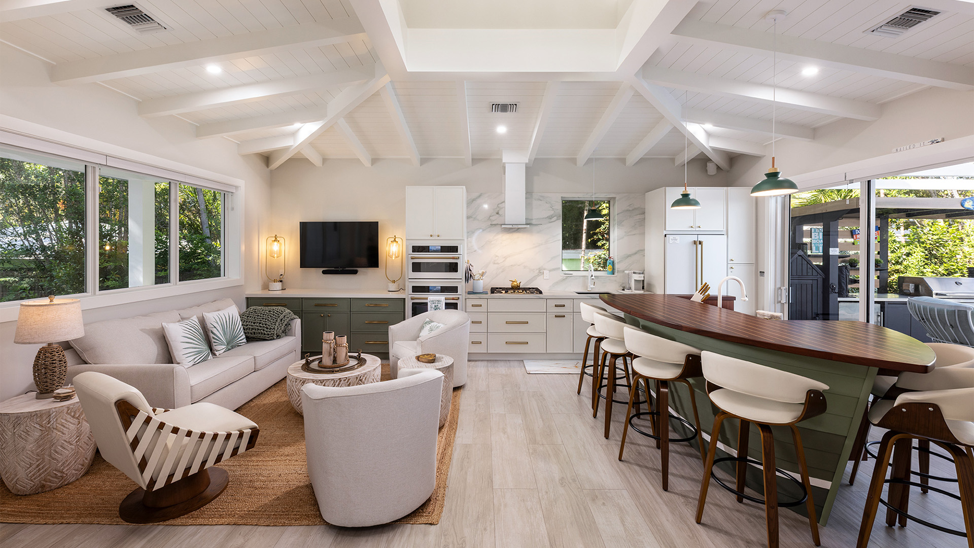 a living room with a kitchen and dining area