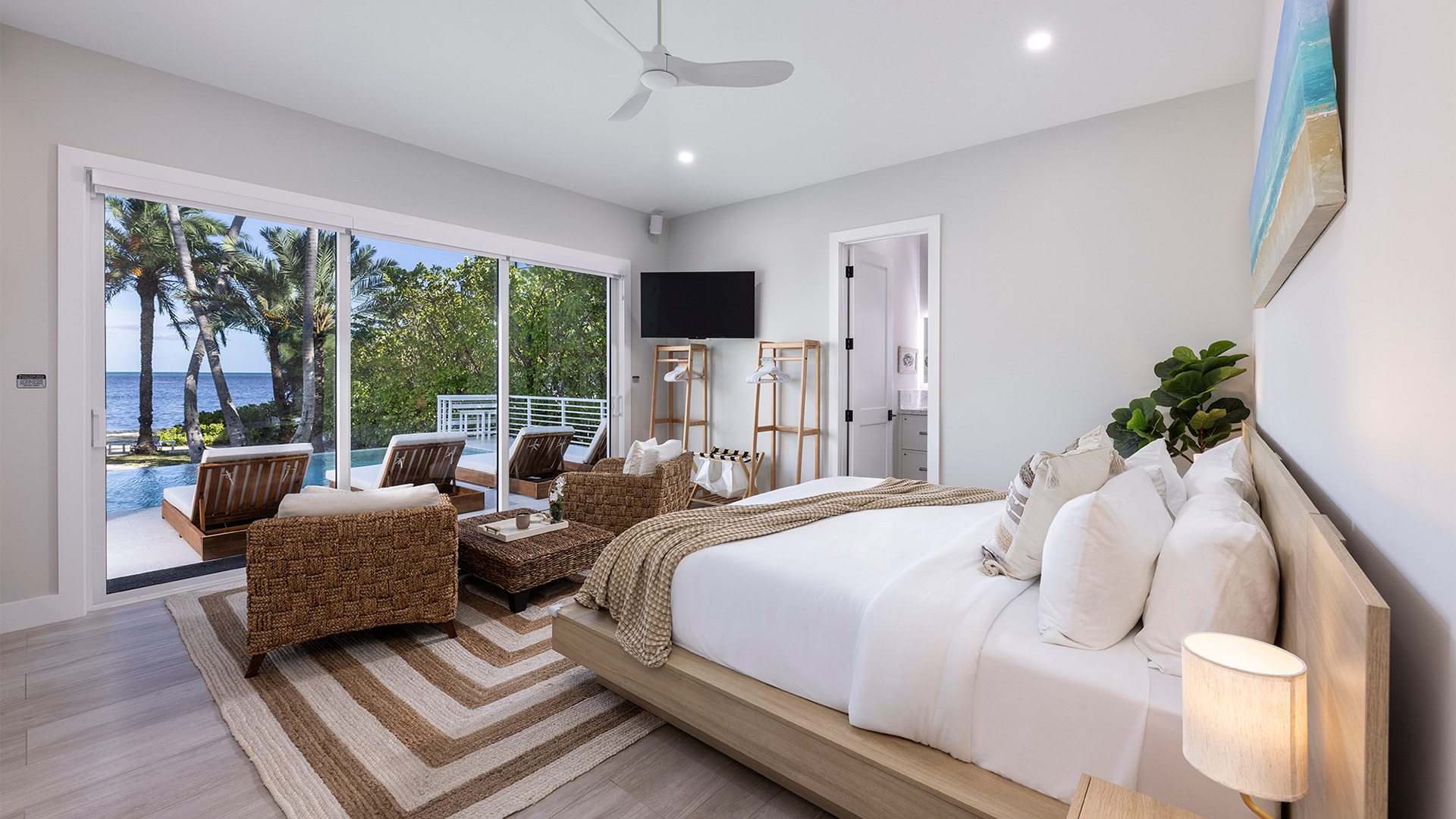 a bedroom with a bed and a chair and a television