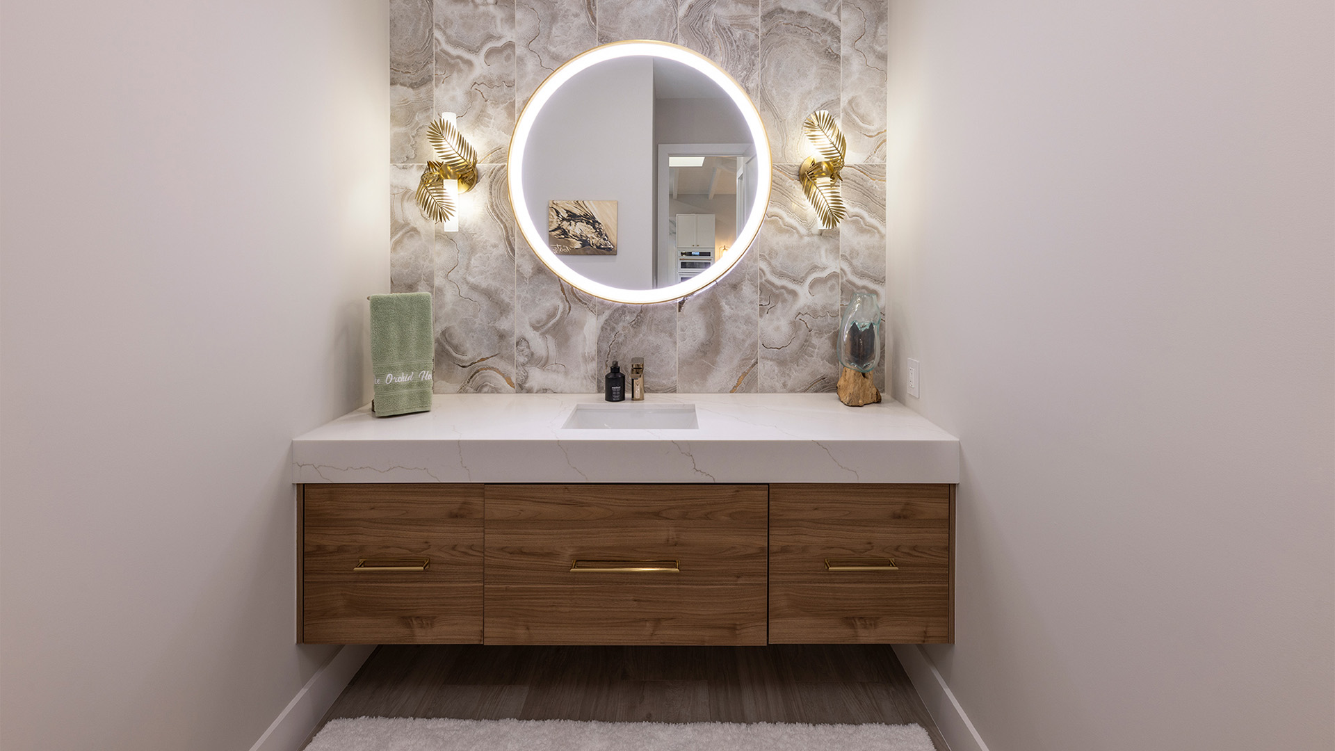 a bathroom with a round mirror