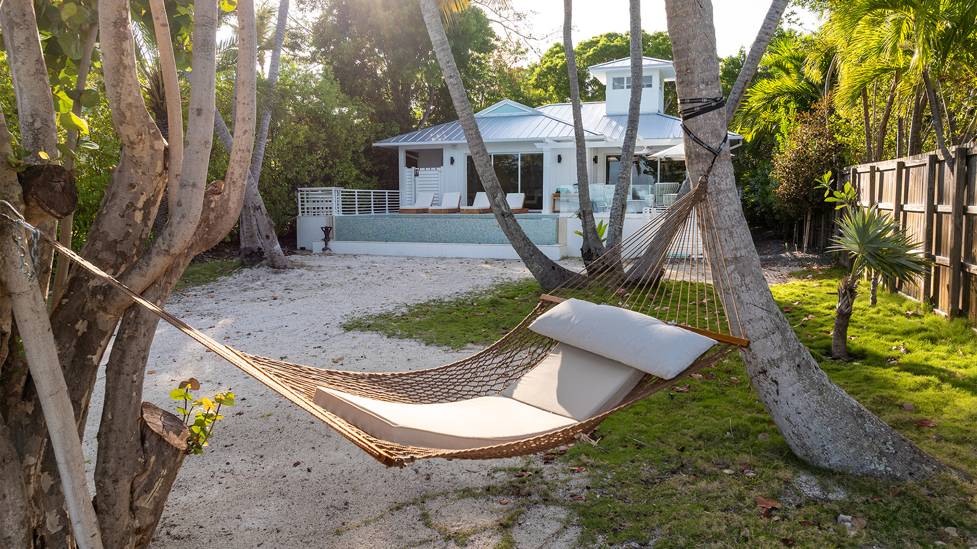 a hammock between trees in a yard