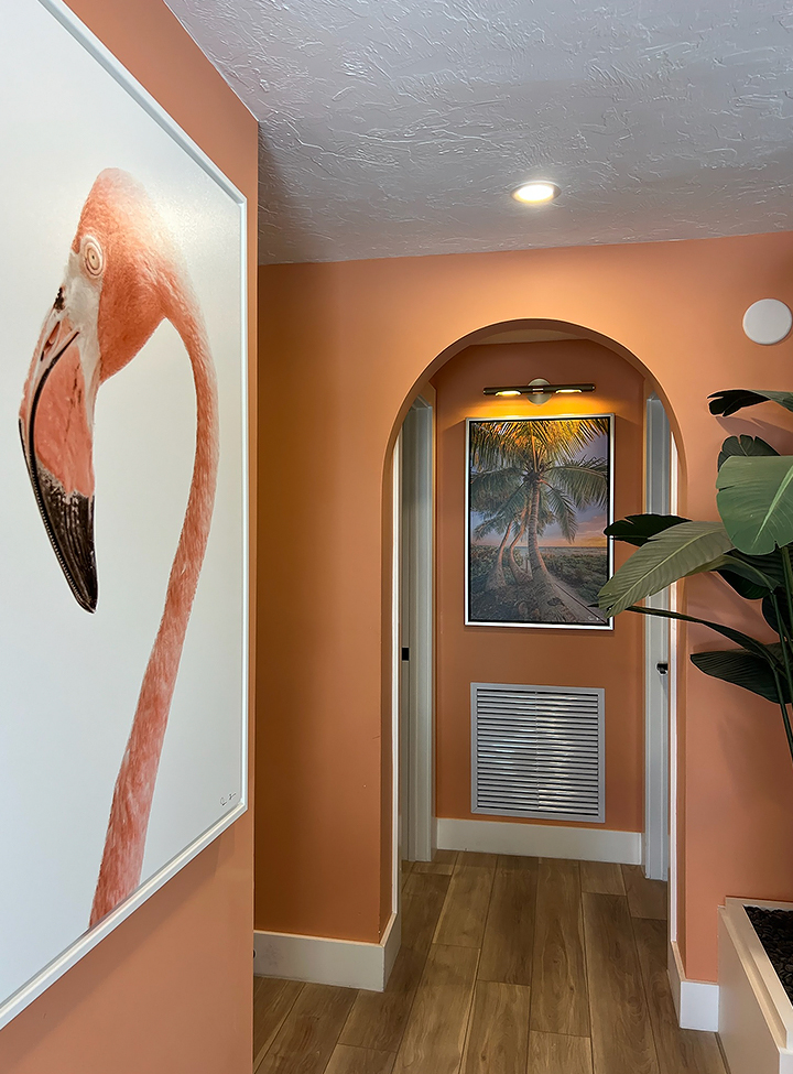 a painting of a flamingo on a wall in a hallway