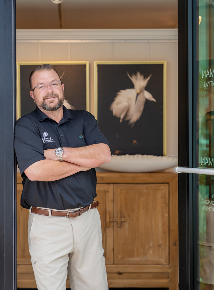 a man standing in front of a glass door