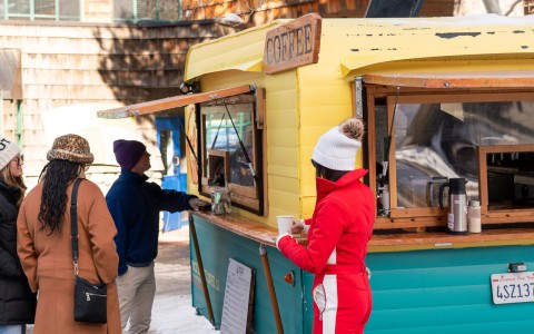 a woman standing at a coffee shop