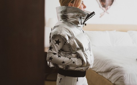 a woman wearing a silver puffer jacket