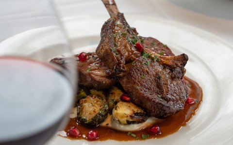 a plate of food with a glass of wine