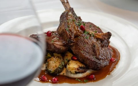 a plate of food with a glass of wine