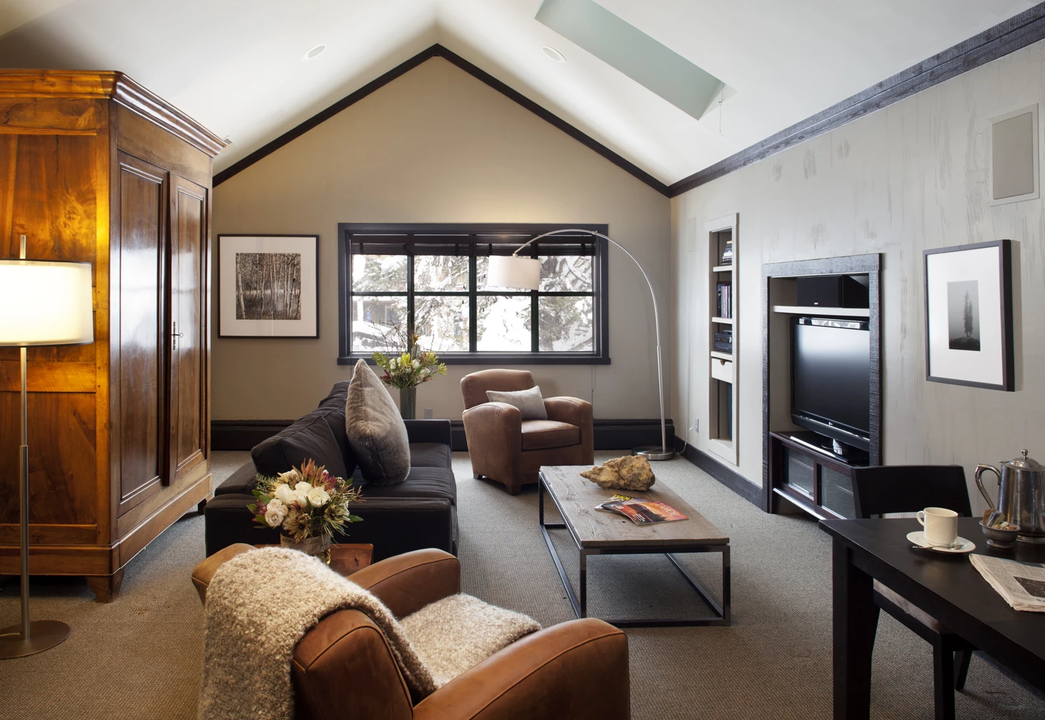 a living room with a tv and couches