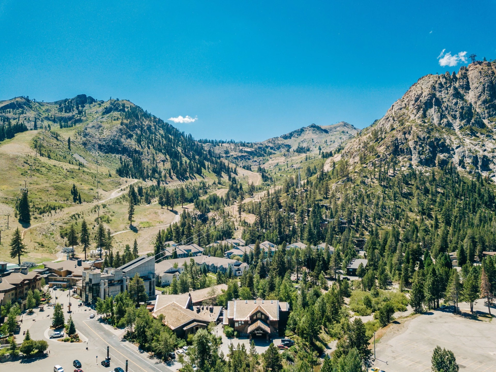 a town in a valley with trees and mountains