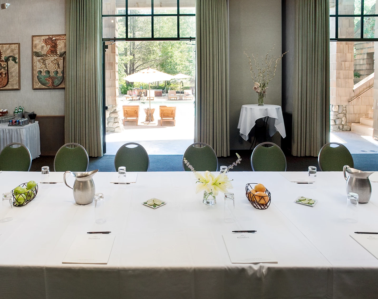 a table with white tablecloths and a vase of flowers