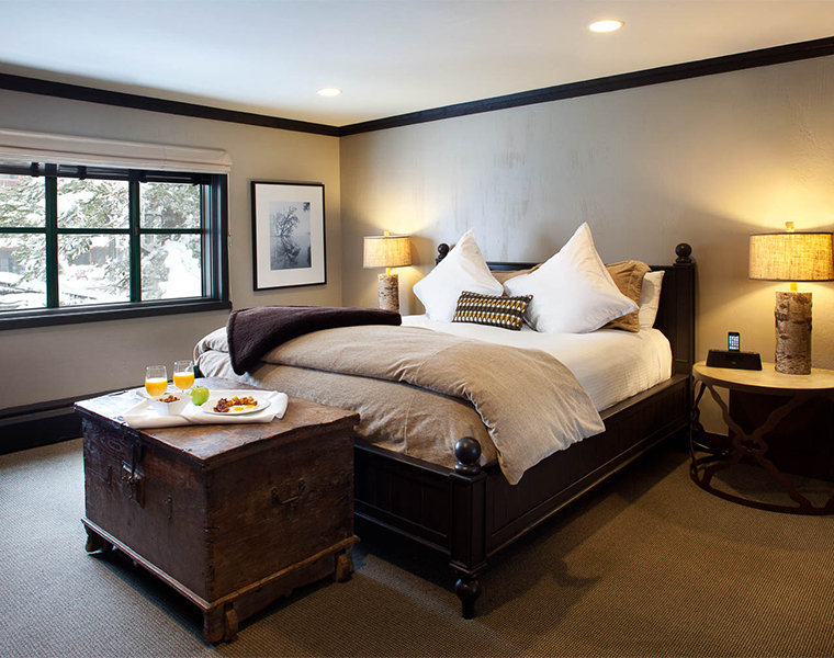 a bed with a table and a tray of food