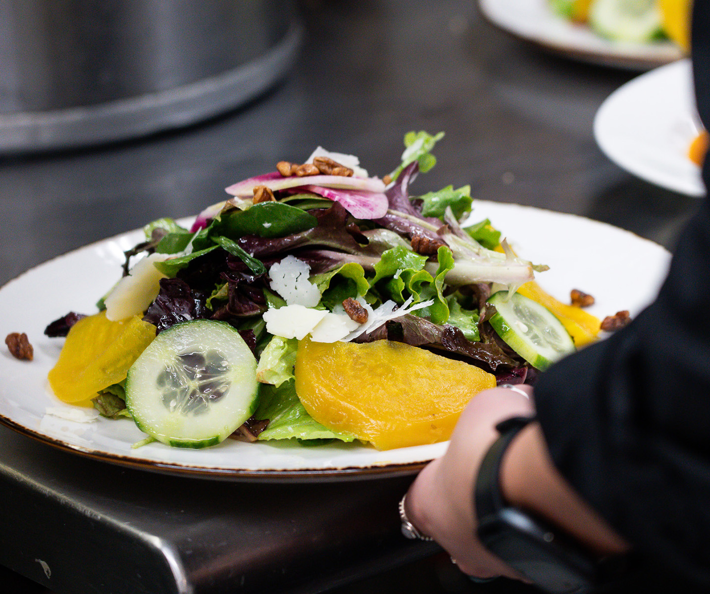 a plate of salad with vegetables and cheese