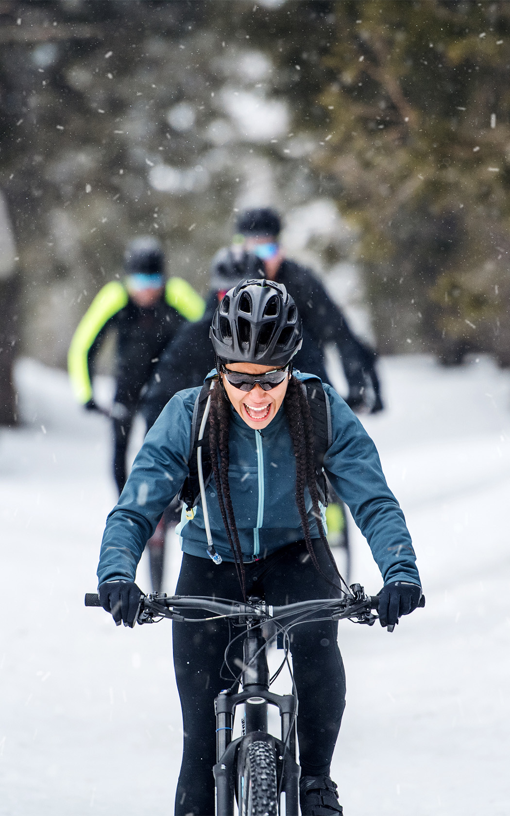 a woman riding a bike in the snow