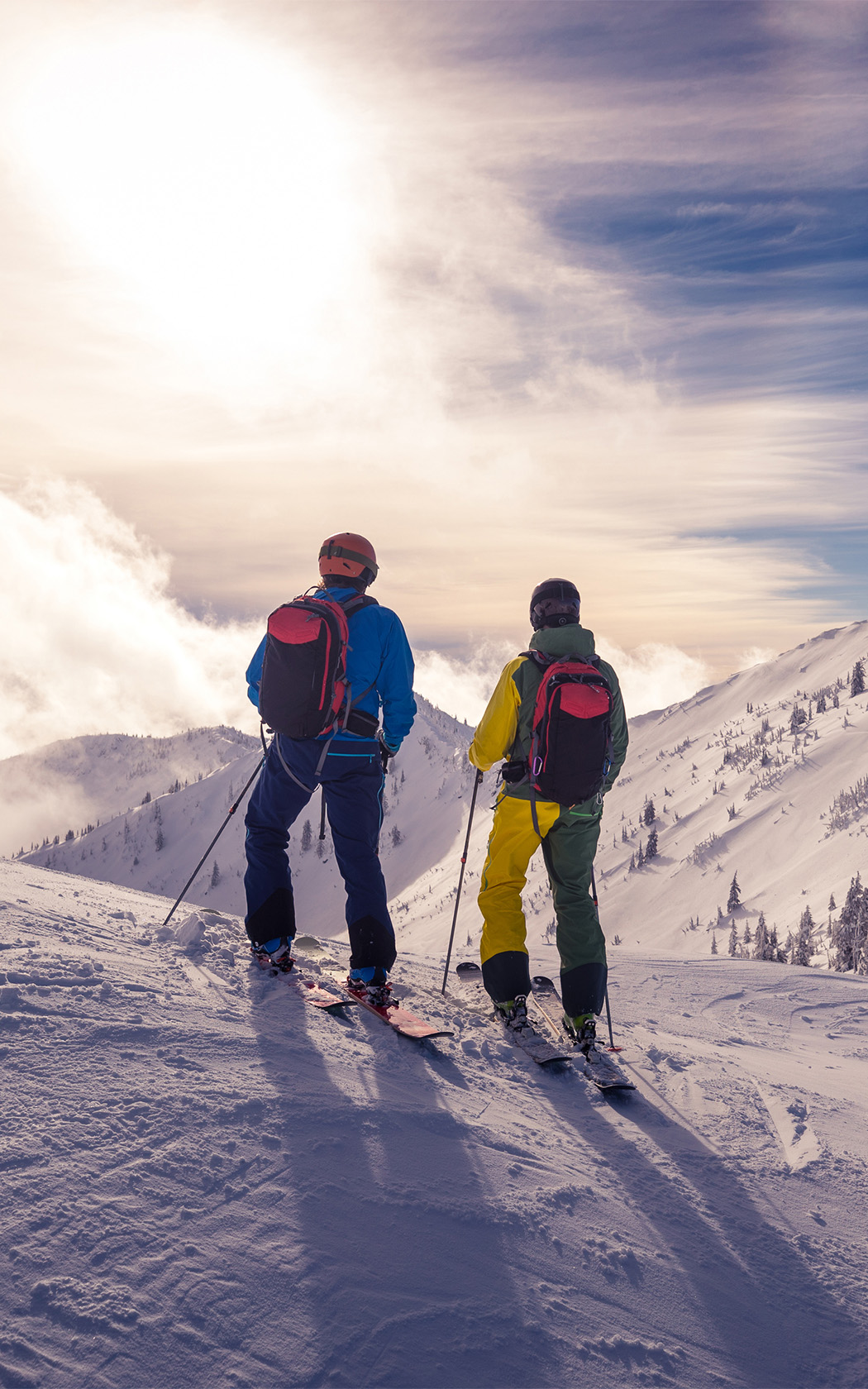 two people on skis on a snowy mountain
