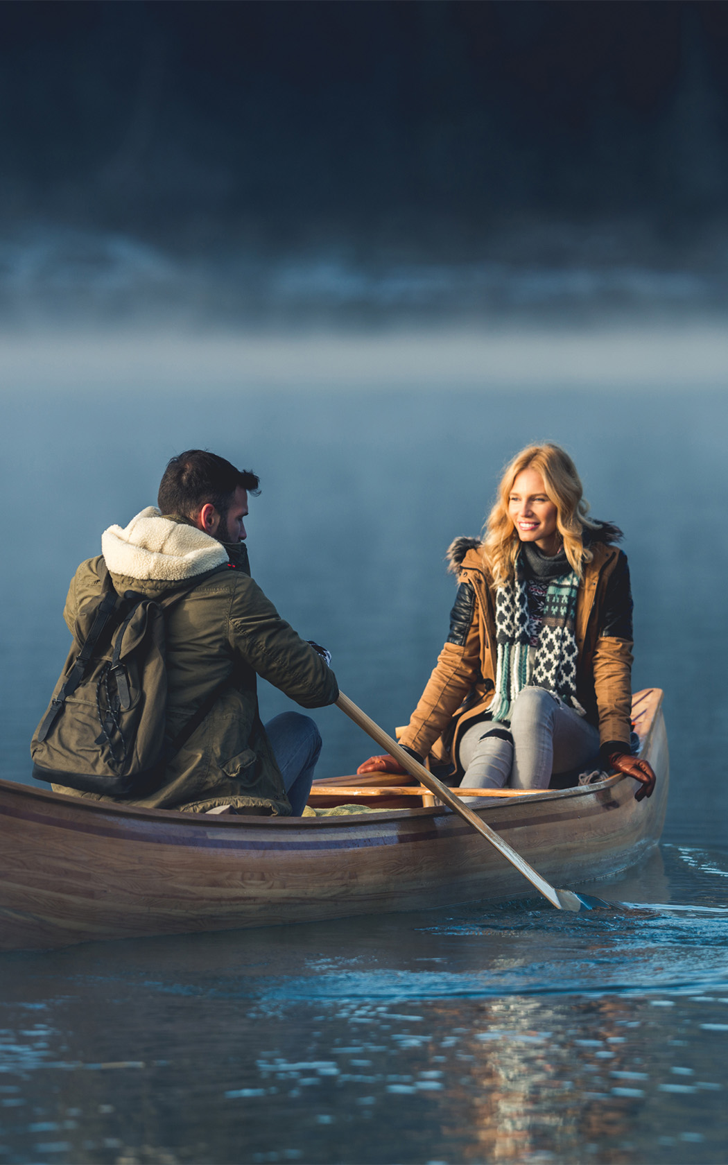 a man and woman in a canoe