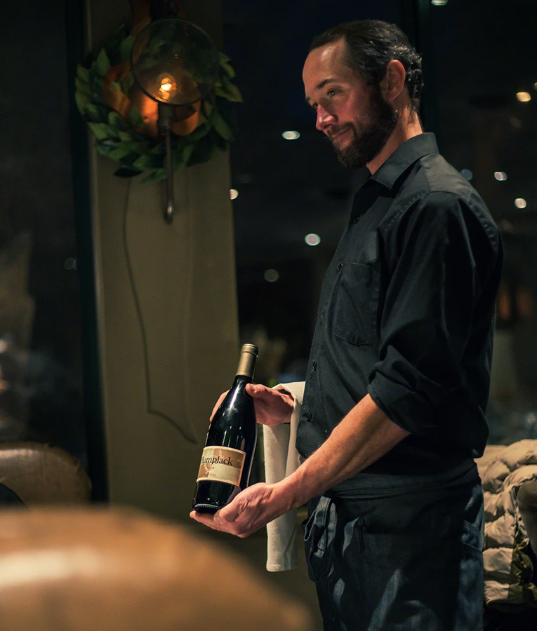 a man holding a bottle of wine