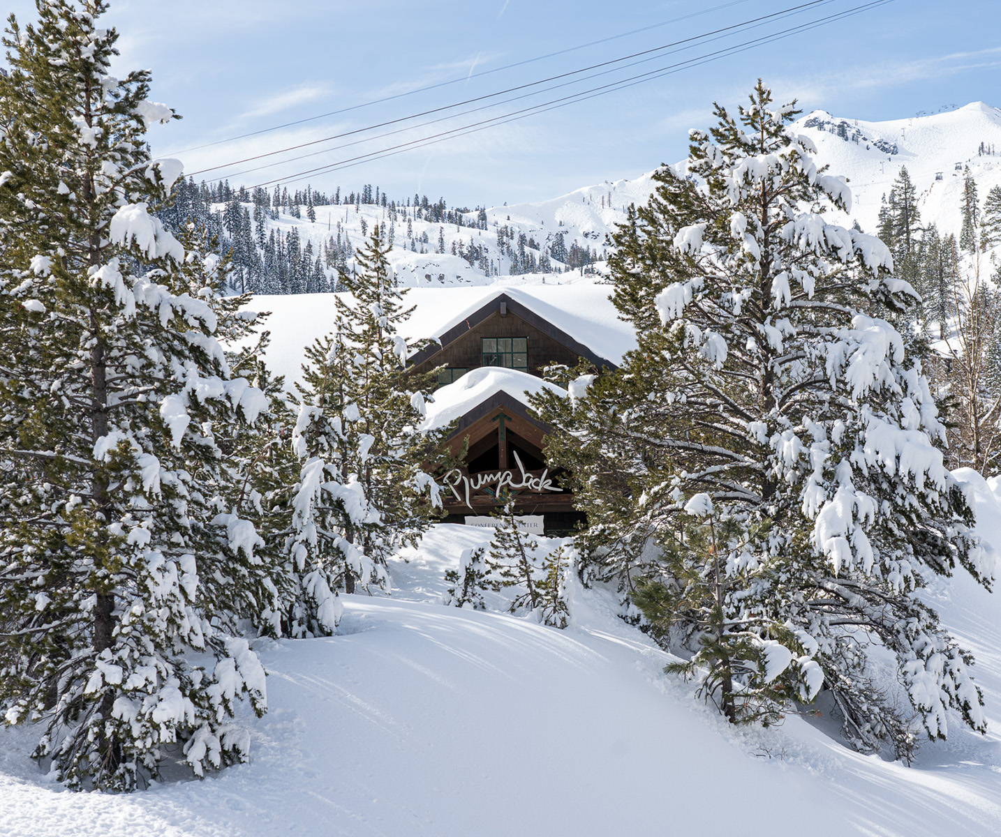 a house surrounded by snow