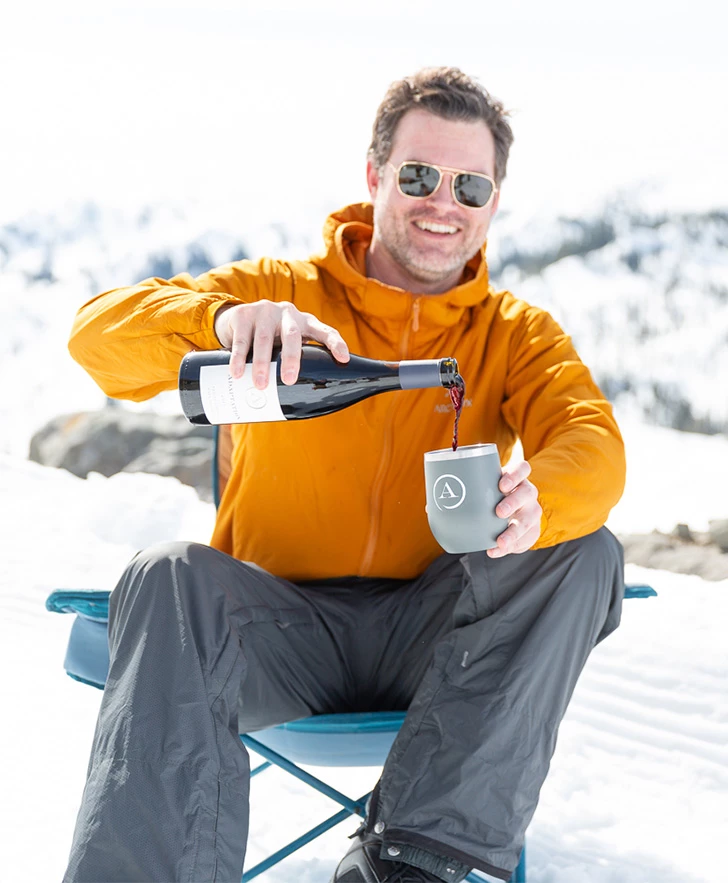 a man pouring wine into a cup