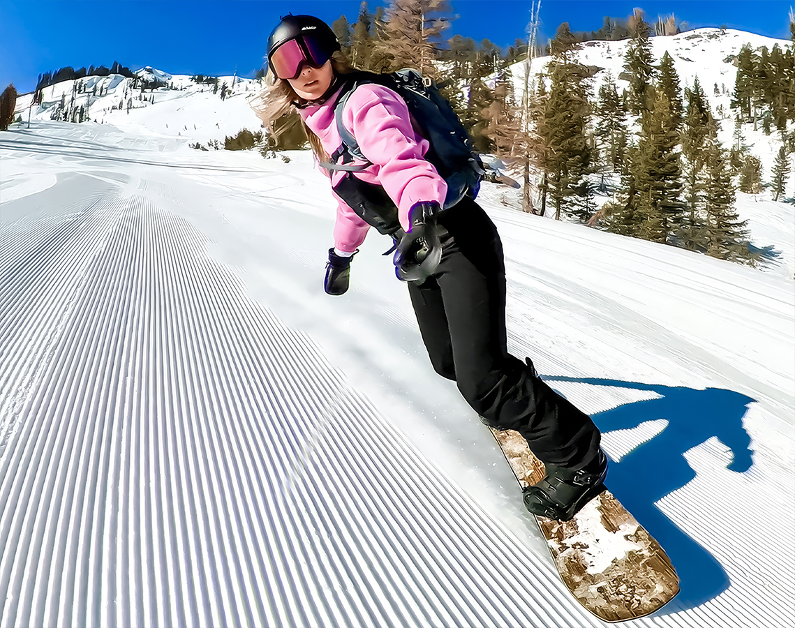 a woman snowboarding down a slope