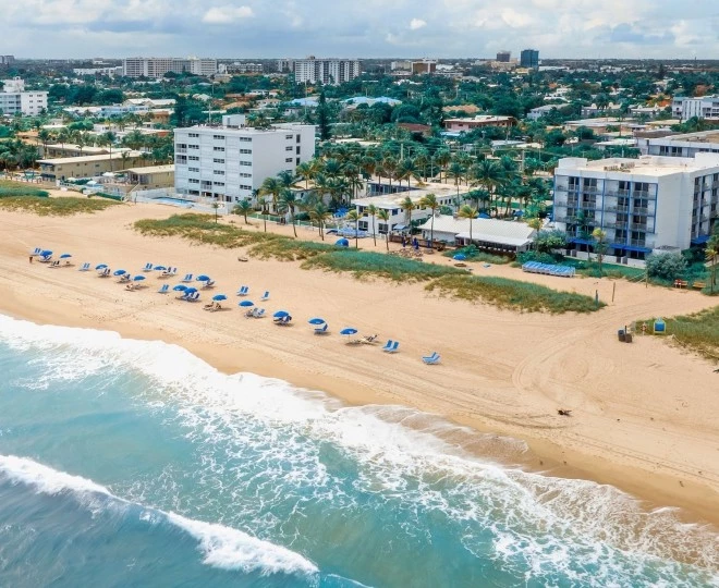 a beach with many chairs and umbrellas