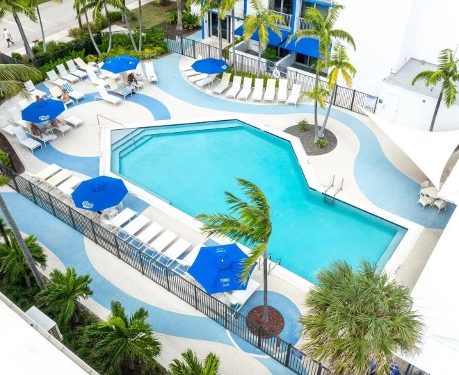 a pool with umbrellas and palm trees