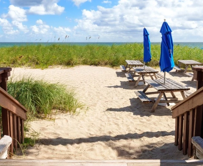 a picnic tables and umbrellas on a beach