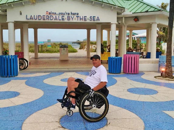 man in a wheelchair in front of the hotels entrance